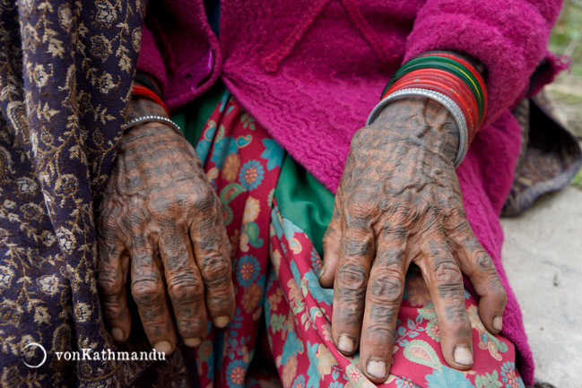 Traditional tattoos on the hands of an old Tharu woman