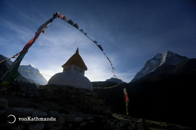 Lhotse and Ama Dablam frame a small monument