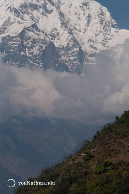 A Gurung house dwarfed by the giant massif of Annapurna South
