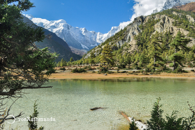 Crytal clear waters of a tiny lake near Pisang with Annapurna in the background