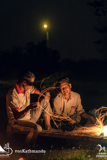 Local Tharus breading ropes out of elephant grass while singing Sadana in the Burhan campsite 