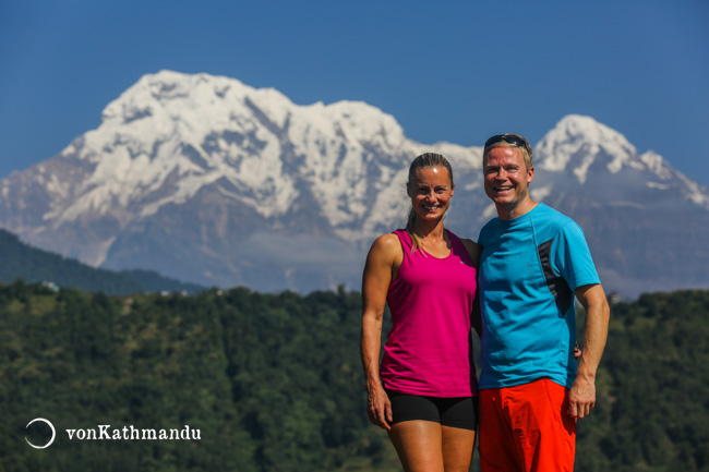 Trekkers posing in front of Annapurna South and Hiuchuli mountains