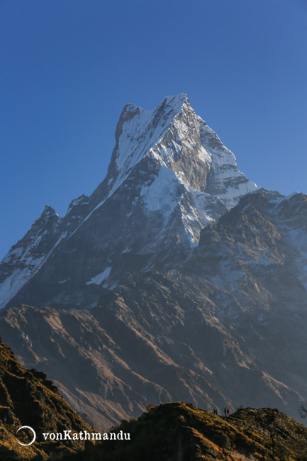 Trekkers admiring the grand scale and beauty of Fishtail Mountain