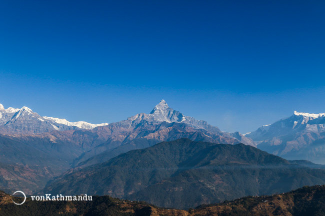 Annapurna mountain range appears almost symmetrical from Kaskikot. Fishtail or Machhapuchare mountain stands oout the most, right in the center