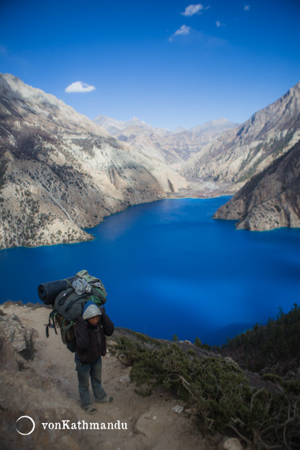 A porter crossing over a small pass to Forest Camp from Ringmo