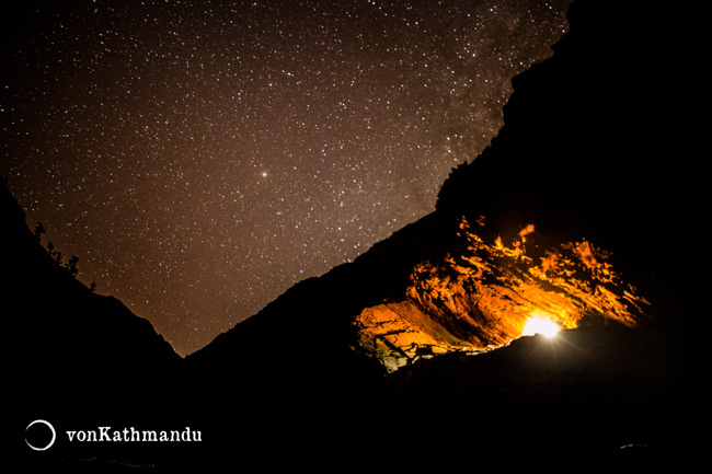 Campfire in a den on a starry night