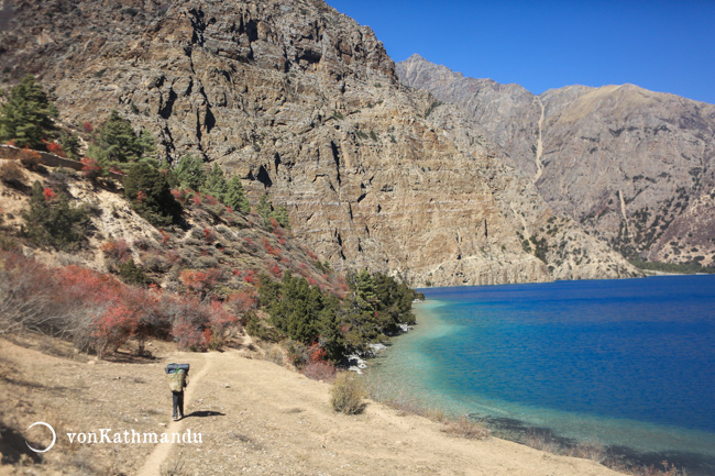 A porter carries goods to the tiny hamlet of Shey Gompa