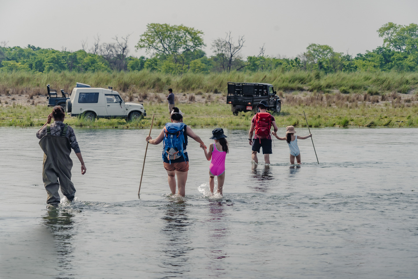 A family crossing the Khauraha river from Burhan camps with the guide