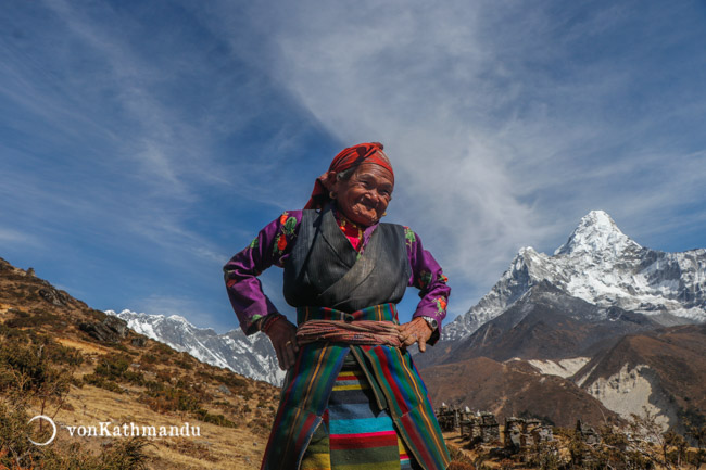 A lady in Pangboche clad in vibrant Sherpa attire called Bakkhu