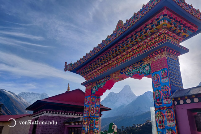 Ama Dablam seen through the ornately decorated gate of Tengboche Monastery. Everest is seen on the left of the gate.