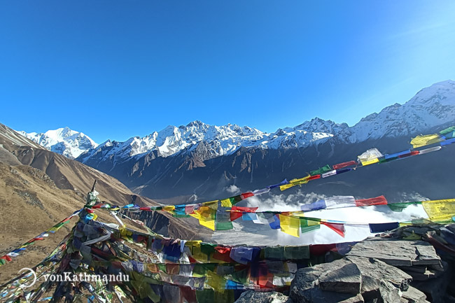 Fluttering prayer flags atop the first viewpoint of Kyanjin