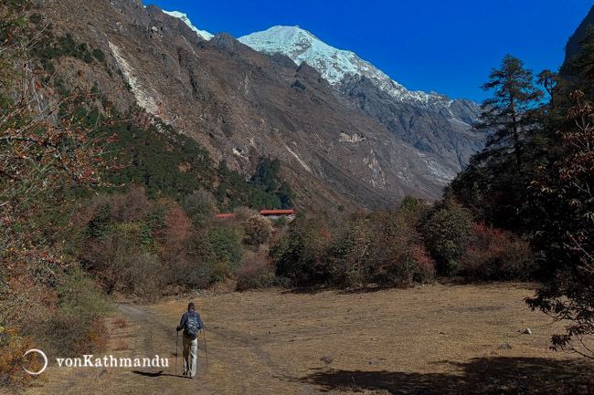 Trekker walking towards Ghoda tabela on scenic pastures