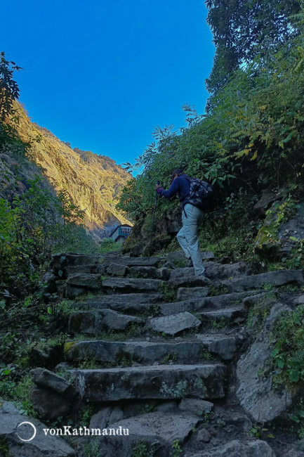 Trekker walking on steep uphill trails to Lama hotel