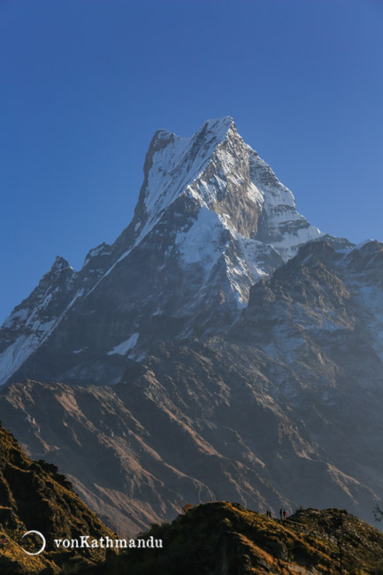 Trekkers admiring the grand scale and beauty of Fishtail Mountain