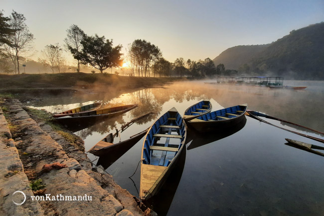 Boats on Phewa Lake, steaming under the morning sun