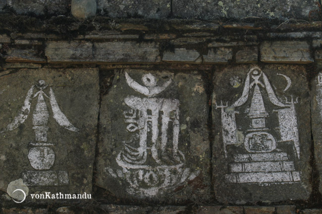 Buddhist symbols carved on a mani wall