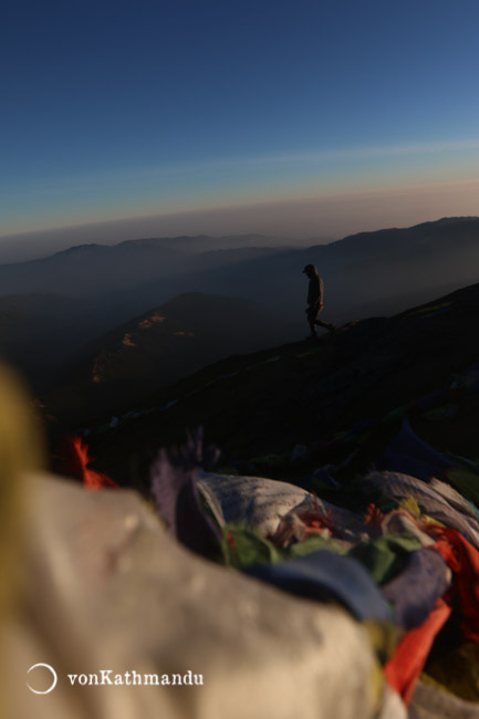 Prayer flags flutter in the chilly dawn atop Pikey Peak