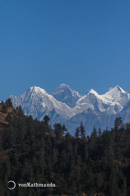 Mount Everest peeks between smaller neighboring mountains in the Khumbu region, seen here from Pattale