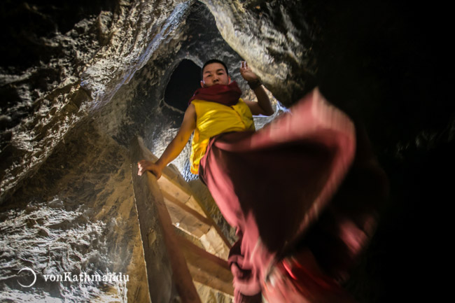 A monk navigates intricate passage of multistorey caves of Chhoser